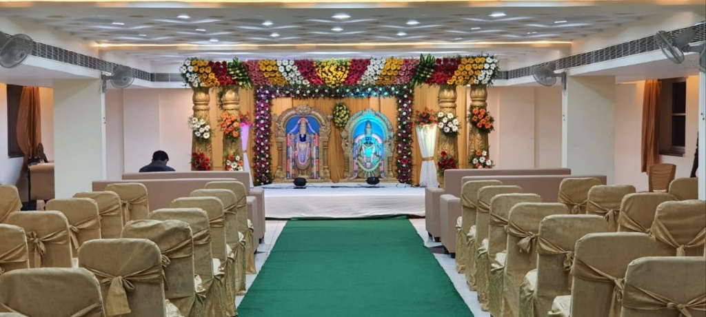 Royal Wedding Hall Setup with Golden Banquet Seating and Illuminated Stage